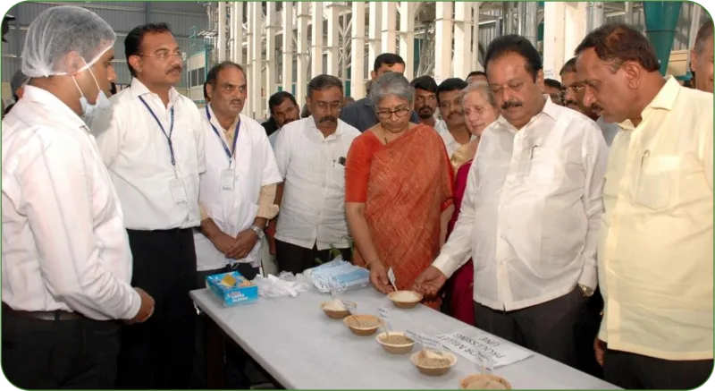 Dignitaries at the Centre of Excellence on Millets, looking at millet products laid out on a table
