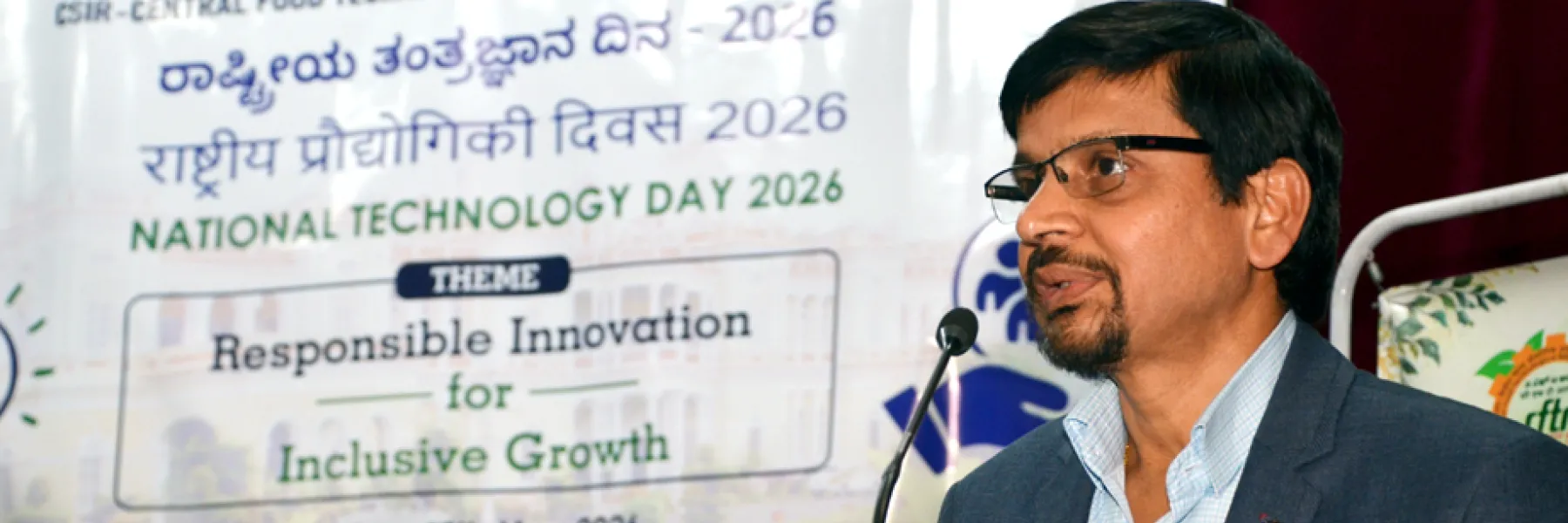 A speaker addressing the National Technology Day 2026 event at CSIR-CFTRI; theme: Responsible Innovation for Inclusive Growth