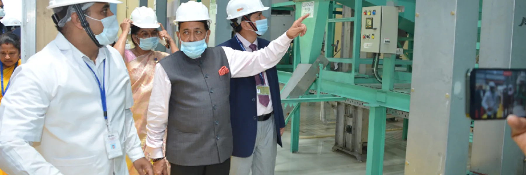 Dr. Jitendra Singh visiting a grain processing plant at CSIR-CFTRI with officials, all wearing safety helmets